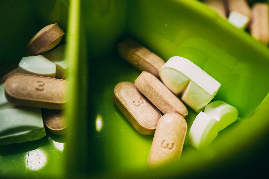 Pills in a green container.