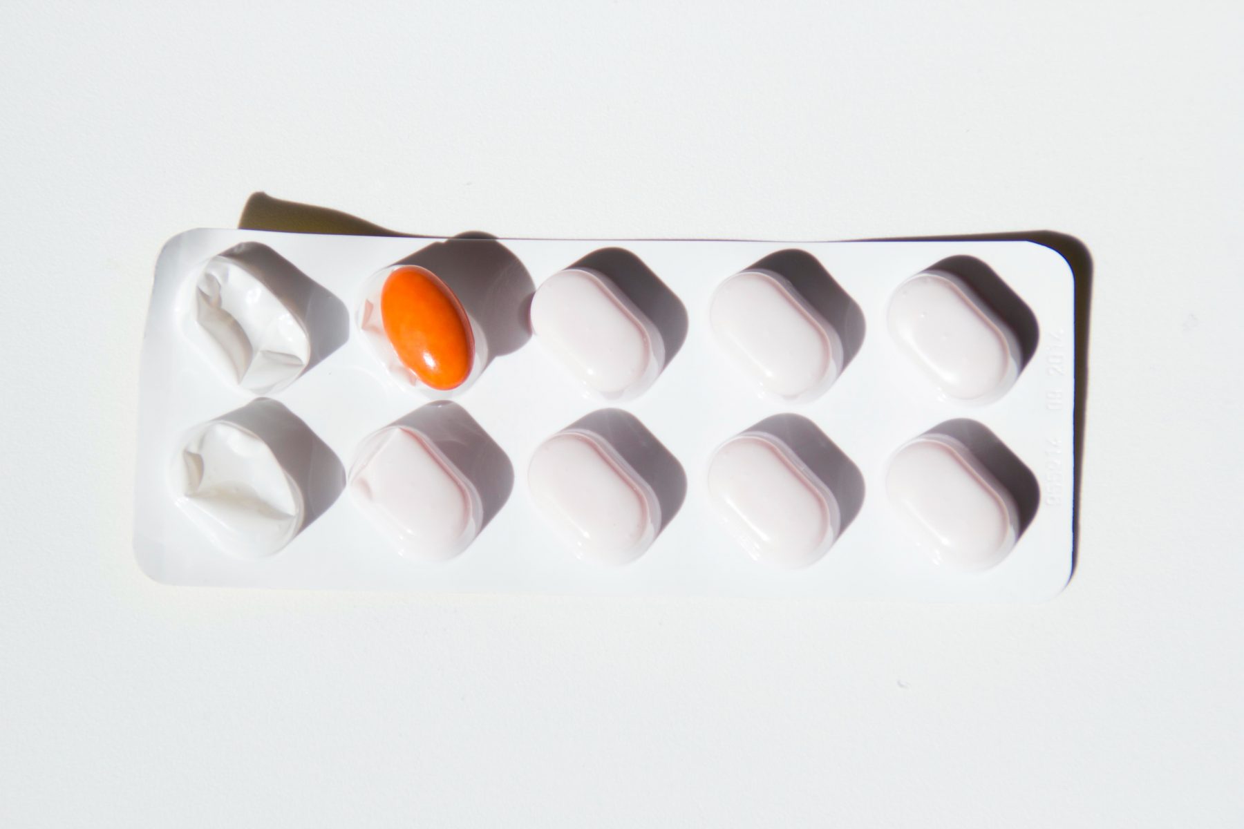Pills sachet with an orange pill on the second slot.