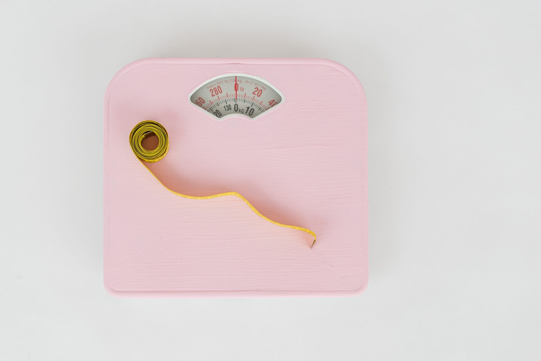 Measuring tape on a pink scale.