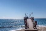 People walking on a pier in Marbella.