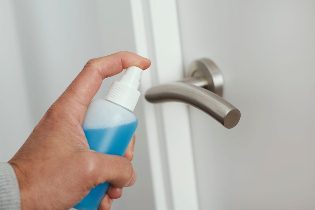 Man with mysophobia afraid to touch door handle without disinfecting